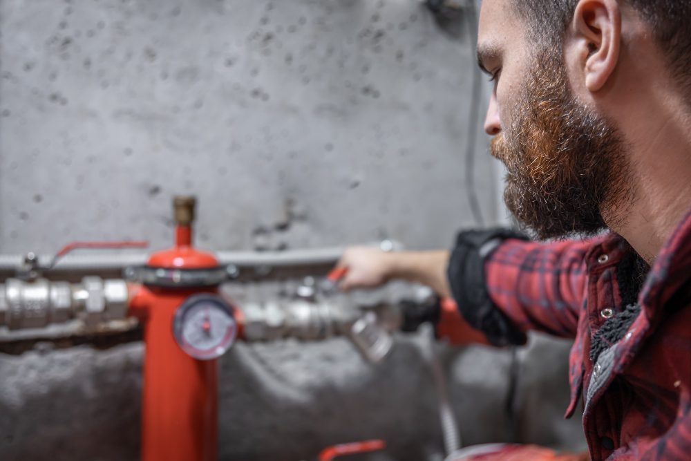 man-looks-faucet-pipes-valve-pressure-meter the man looks at the faucet, pipes, valve, pressure meter.